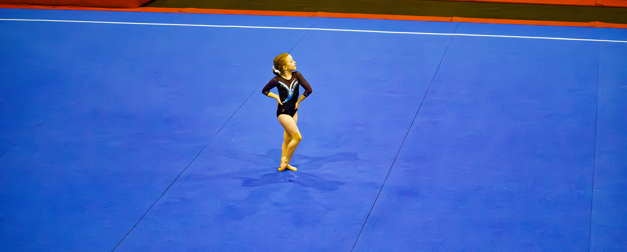 A young gymnast training in the gym